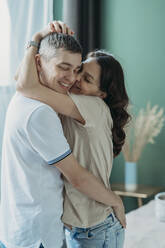 Happy couple hugging at home - ANAF02524