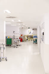 Empty hospital with equipment near white colored wall - MMPF01043