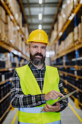 Portrait of a warehouse worker or a supervisor with digital tablet. - HPIF31149