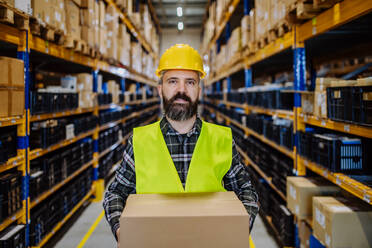 Warehouse worker stocking goods in warehouse. - HPIF31154