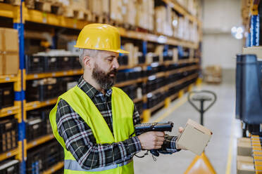 Warehouse worker checking up stuff in warehouse. - HPIF31164