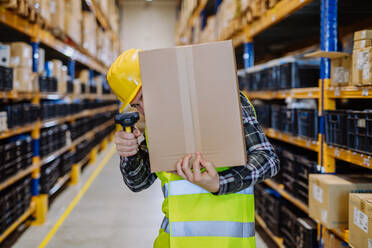 Warehouse worker stocking goods in warehouse. - HPIF31165