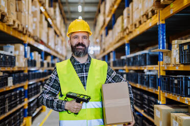 Warehouse worker stocking goods in warehouse. - HPIF31166