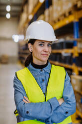 Portrait of a warehouse female worker in reflective vest. - HPIF31168