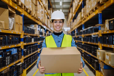 Warehouse female worker checking up stuff in warehouse. - HPIF31183