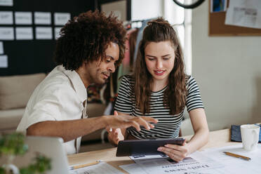 Young colleagues working together in a startup company. - HPIF31263