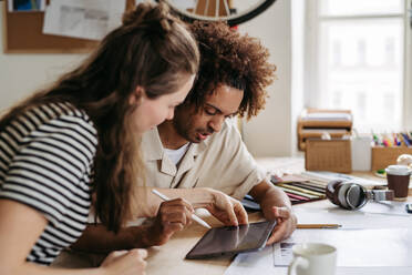 Young colleagues working together in a startup company. - HPIF31265