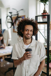 Portrait of young multiracial man in an office. - HPIF31298