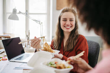 Young colleagues having lunch time in the office. - HPIF31312