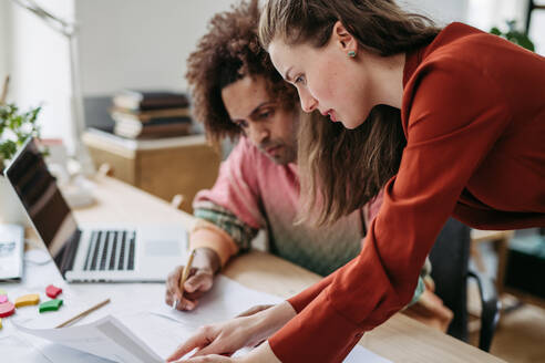 Young colleagues working together in a startup company. - HPIF31321