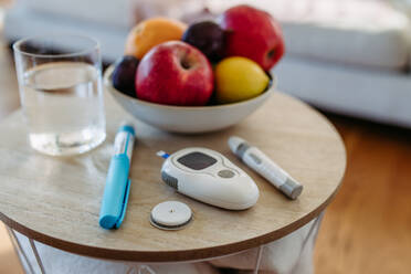 Nahaufnahme von Diabetes-Zubehör und -Geräten auf dem Tisch. Kontinuierlicher Glukosemonitor, Insulin-Pen, Blutzuckermessgerät. Bild mit Kopierbereich. - HPIF31410