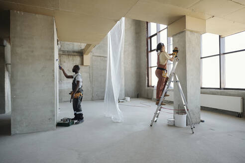 Construction workers working on wall at site - DSHF01369