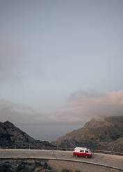 Van moving on road overlooking mountains against sky - MASF40792