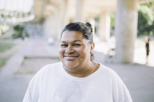 Portrait of smiling oversized woman wearing white t-shirt - MASF40963