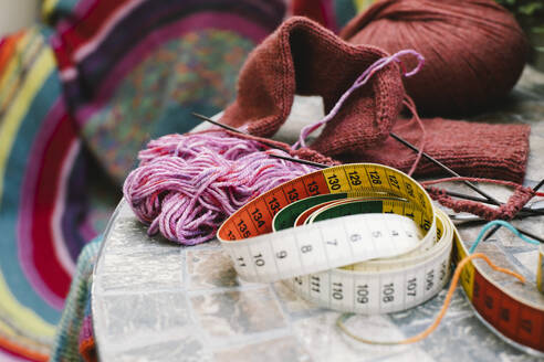 Crafting essentials - tape measure, wool, and knitting needles - set the scene for a cozy knitting session - MASF41158