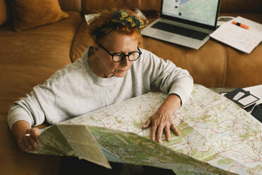 An adventurous senior maps out her next journey from the cozy confines of her living room - MASF41165