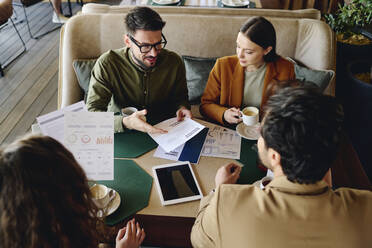 Business colleagues having project meeting at restaurant - DSHF01387