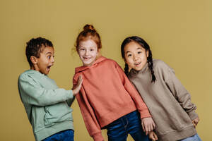 Portrait of three excited children, studio shoot. Concept of diversity in a friendship. - HPIF32030