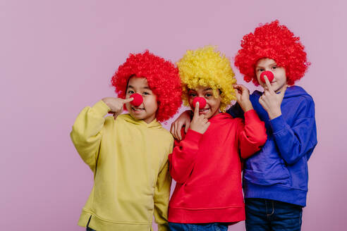 Happy children playing on clown, studio shoot. - HPIF32042