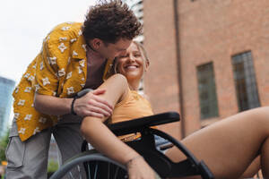 Beautiful gen Z girl in a wheelchair with her boyfriend. Inclusion, equality, and diversity among Generation Z. - HPIF32306