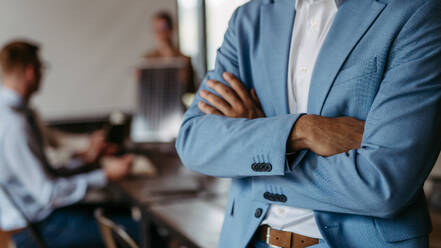 Close up of businessman with crossed arms during meeting. - HPIF32345