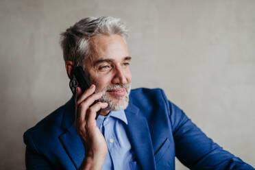Portrait of businessman calling with his smartphone. - HPIF32375