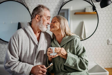 Senior couple having morning routine in the bathroom. - HPIF32445