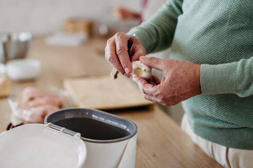 A close-up shot of fresh garlic, peeling and separating cloves from bulb. - HPIF32450