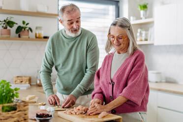 Senior couple cooking together in the kitchen. - HPIF32454