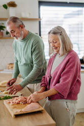 Senior couple cooking together in the kitchen. - HPIF32461