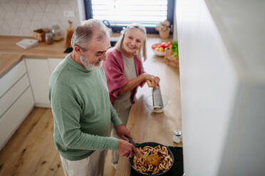 Senior couple cooking together in the kitchen. - HPIF32473