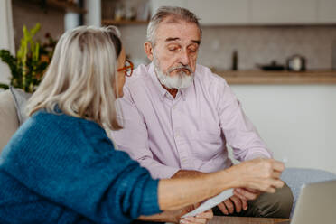 Senior couple checking their bills, concept of finance. - HPIF32489