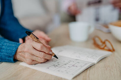 Close up of senior woman doing sudoku. - HPIF32502
