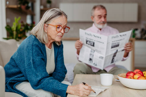 Senior couple spending leisure time together in the living room. - HPIF32503