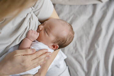 Woman breastfeeding newborn son in arms - NDEF01463