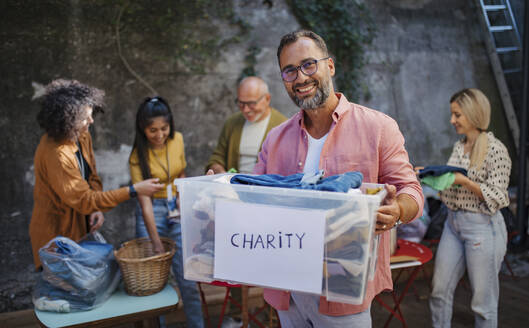 People donating and collecting clothes for charity - HAPF03600