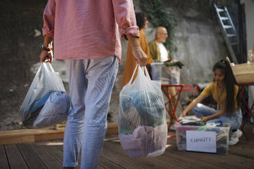 People sorting used clothes for charity - HAPF03607