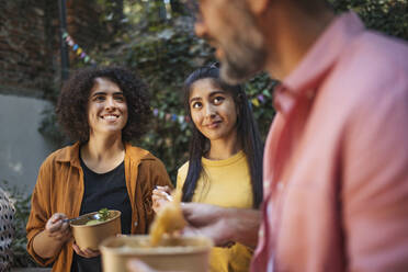 Happy people having fun eating together in garden - HAPF03618