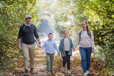 Happy family with kids walking in a forest. - HPIF32724