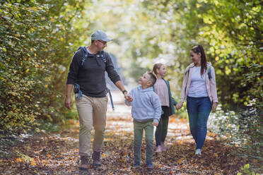 Happy family with kids walking in a forest. - HPIF32726