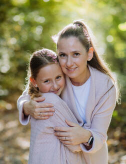 Portrait of mother with her daughter in a forest. - HPIF32733