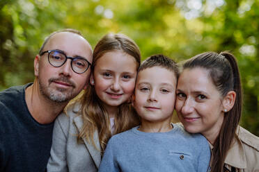 Portrait of happy family with kids in forest. - HPIF32751