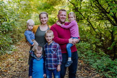 Portrait of happy family with kids in forest. - HPIF32752