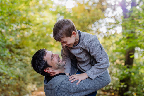 Father having fun with his son in a forest. - HPIF32760