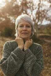 Smiling mature woman with gray hair in nature - EBSF04174