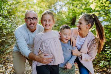 Portrait of happy family with kids in forest. - HPIF32770