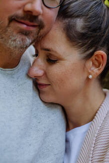 Portrait of happy couple in love,standing in a forest. - HPIF32781