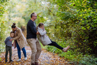 Happy family having fun with kids in forest. - HPIF32783