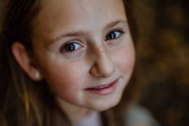 Portrait of girl standing outdoor in a forest. - HPIF32786