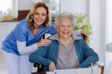 Portrait of nurse and her senior client on a wheelchair. - HPIF32823